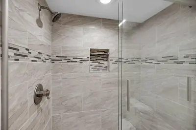 a bathroom with a shower with a glass door at Commodore 801 (3/3) in Panama City Beach