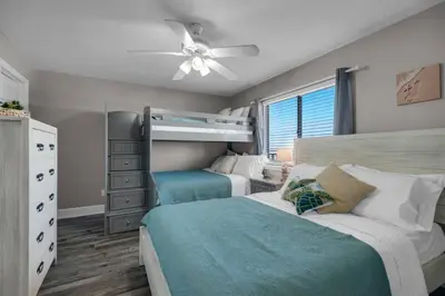 a bedroom with two beds and a ceiling fan at Commodore 801 (3/3) in Panama City Beach