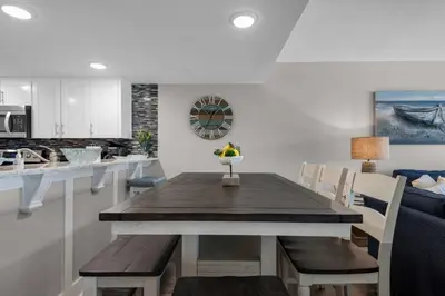 a dining room and kitchen with a table and chairs at Commodore 801 (3/3) in Panama City Beach