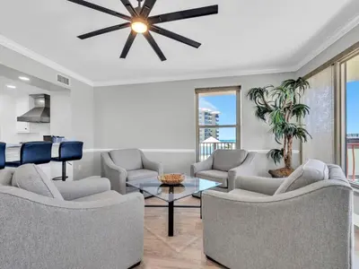 a living room with couches and a ceiling fan at Hidden Dunes 305 in Panama City Beach