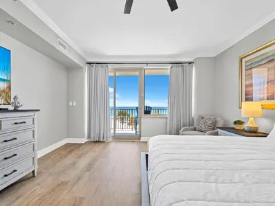 a bedroom with a bed and a view of the ocean at Hidden Dunes 305 in Panama City Beach