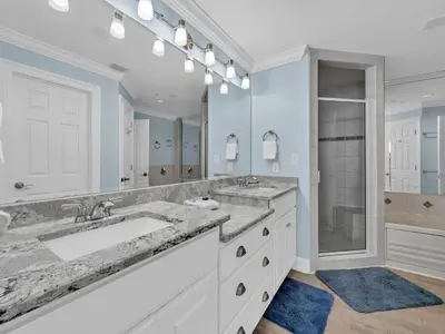 a bathroom with two sinks and a large mirror at Hidden Dunes 1704 in Panama City Beach