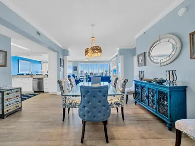 a dining room with a blue table and chairs at Hidden Dunes 1704 in Panama City Beach
