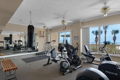 a gym with exercise equipment and a large window at Hidden Dunes 1704 in Panama City Beach
