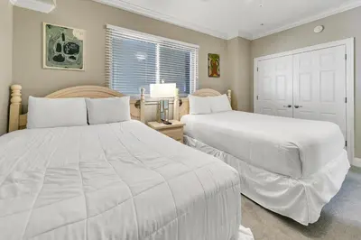 a bedroom with two beds and a window at Hidden Dunes 1303 in Panama City Beach