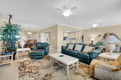 a living room with a couch and a table at Hidden Dunes 1703 in Panama City Beach