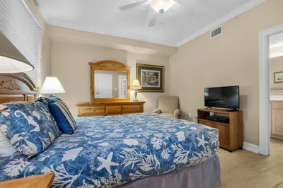 a bedroom with a bed and a flat screen tv at Hidden Dunes 1703 in Panama City Beach