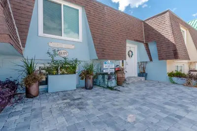 a house with potted plants in front of it at Sunny Beach by Book That Condo in Panama City Beach