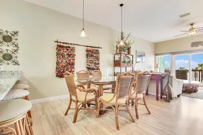 a kitchen and dining room with a table and chairs at Seaside Pointe by Book That Condo in Panama City Beach