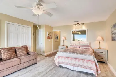 a bedroom with a bed and a couch at Seaside Pointe by Book That Condo in Panama City Beach