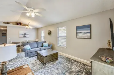 a living room with a couch and a ceiling fan at Poolside Cabana by Book That Condo in Panama City Beach