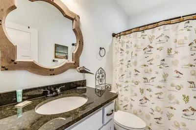 a bathroom with a sink and a shower curtain at Sandy Feet Retreat by Book That Condo in Panama City Beach