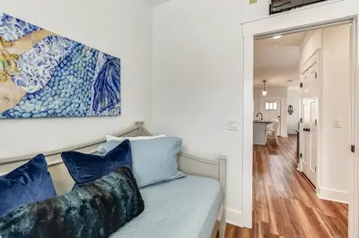 a living room with a couch and a painting on the wall at Sandy Feet Retreat by Book That Condo in Panama City Beach
