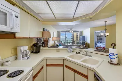 a kitchen with a sink and a microwave at Summerhouse 710B by Book That Condo in Panama City Beach