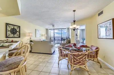a kitchen and dining room with a table and chairs at Summerhouse 710B by Book That Condo in Panama City Beach