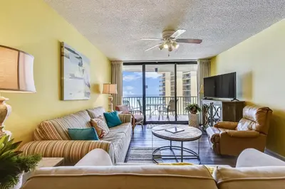 a living room with a couch and a tv at Summerhouse 710B by Book That Condo in Panama City Beach