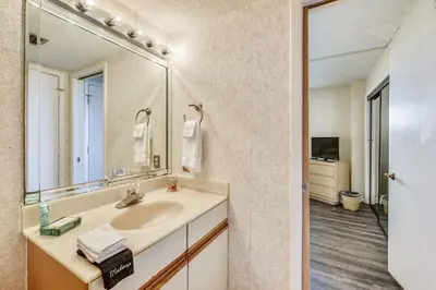 a bathroom with a sink and a mirror at Summerhouse 710B by Book That Condo in Panama City Beach