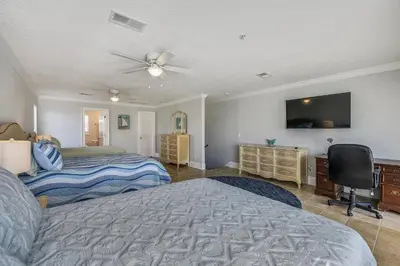 a bedroom with a bed and a flat screen tv at C Dreams by Book That Condo in Panama City Beach