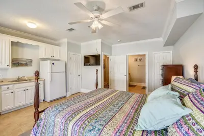 a bedroom with a bed and a white refrigerator at C Dreams by Book That Condo in Panama City Beach