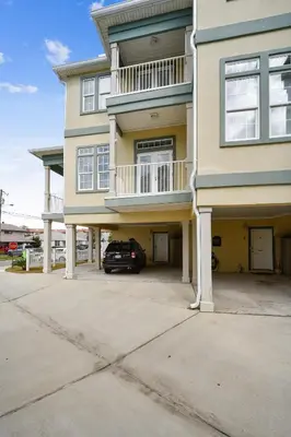 a house with a car parked in front of it at C Dreams by Book That Condo in Panama City Beach