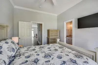 a bedroom with a bed with a blue and white comforter at C Dreams by Book That Condo in Panama City Beach