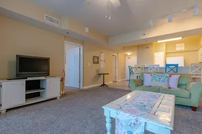 a living room with a couch and a tv at Shores of Panama #612 by Book That Condo in Panama City Beach