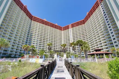 a large building with a bridge in front of it at Shores of Panama #612 by Book That Condo in Panama City Beach