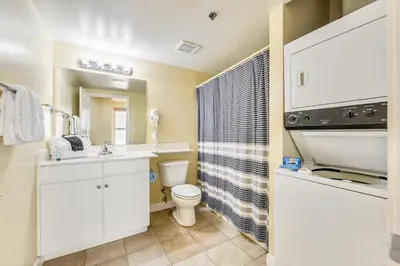 a bathroom with a white sink and a toilet at Shores of Panama #1217 by Book That Condo in Panama City Beach
