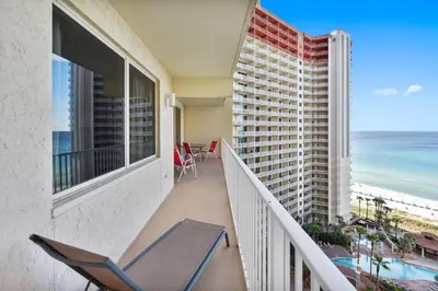 a balcony with a chair and a view of the ocean at Shores of Panama #1217 by Book That Condo in Panama City Beach