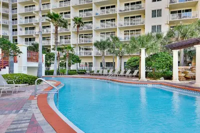 a swimming pool in front of a large building at Shores of Panama #1217 by Book That Condo in Panama City Beach