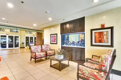 a lobby with chairs and a table in a building at Shores of Panama #1217 by Book That Condo in Panama City Beach