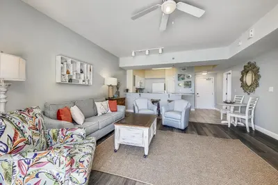 a living room with a couch and a table at Shores of Panama #1411 by Book That Condo in Panama City Beach