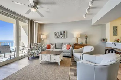 a living room with a view of the ocean at Shores of Panama #1411 by Book That Condo in Panama City Beach