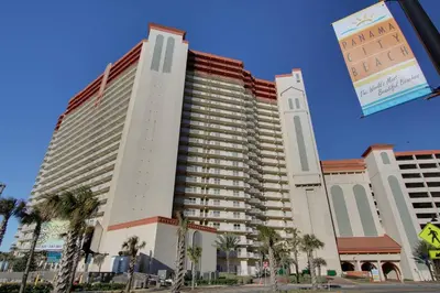 a large building with palm trees in front of it at Shores of Panama #1502 by Book That Condo in Panama City Beach
