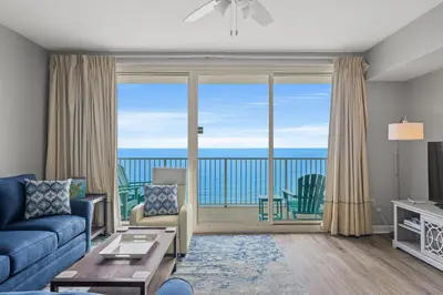 a living room with a view of the ocean at Shores of Panama #1502 by Book That Condo in Panama City Beach