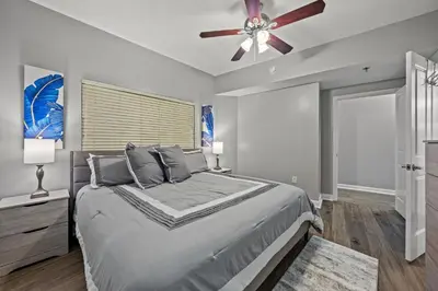 a bedroom with a bed and a ceiling fan at Shores of Panama #1502 by Book That Condo in Panama City Beach