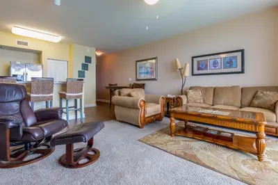 a living room with a couch and a table at Shores of Panama #1502 by Book That Condo in Panama City Beach