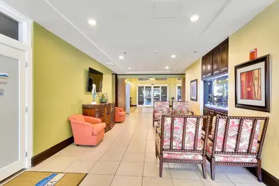 a hallway with chairs and a waiting room at Shores of Panama #1627 by Book That Condo in Panama City Beach