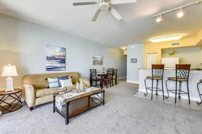 a living room with a couch and a table at Shores of Panama #1627 by Book That Condo in Panama City Beach