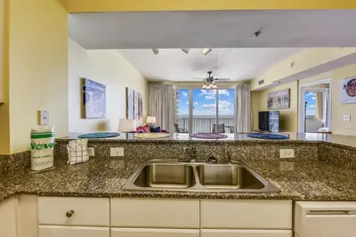a kitchen with a sink and a counter top at Shores of Panama #1714 by Book That Condo in Panama City Beach