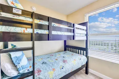 a bedroom with bunk beds and a window at Shores of Panama #1714 by Book That Condo in Panama City Beach