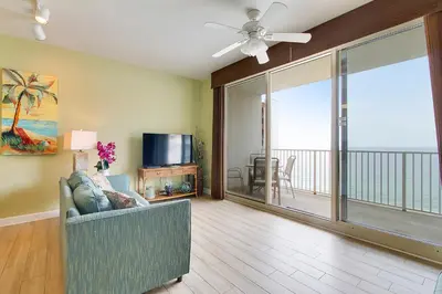 a living room with a couch and a ceiling fan at Shores of Panama #2020 by Book That Condo in Panama City Beach
