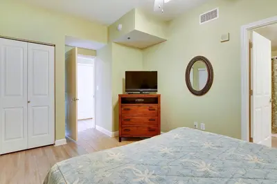 a bedroom with a bed and a television on a dresser at Shores of Panama #2020 by Book That Condo in Panama City Beach