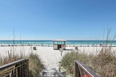 a sandy beach with a lifeguard station and the ocean at Shores of Panama #2020 by Book That Condo in Panama City Beach