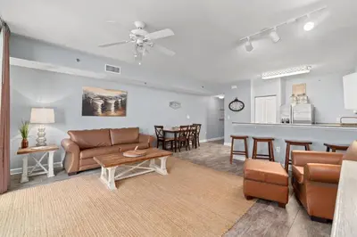 a living room with a couch and a table at Shores of Panama #624 by Book That Condo in Panama City Beach