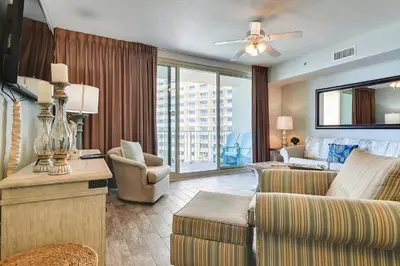 a living room with a couch and a chair at Shores of Panama #624 by Book That Condo in Panama City Beach