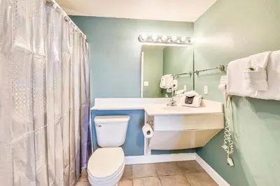 a bathroom with a toilet and a sink at Shores of Panama #1007 by Book That Condo in Panama City Beach