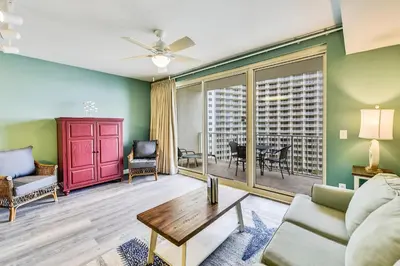 a living room with a couch and a table at Shores of Panama #1007 by Book That Condo in Panama City Beach
