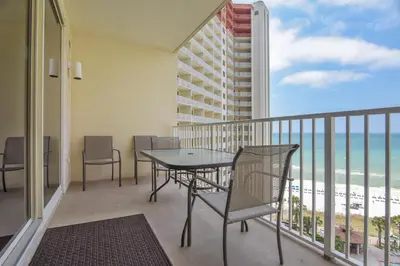 a balcony with a table and chairs and the ocean at Shores of Panama #1119 by Book That Condo in Panama City Beach