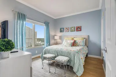 a bedroom with a bed and a window at Shores of Panama #1119 by Book That Condo in Panama City Beach